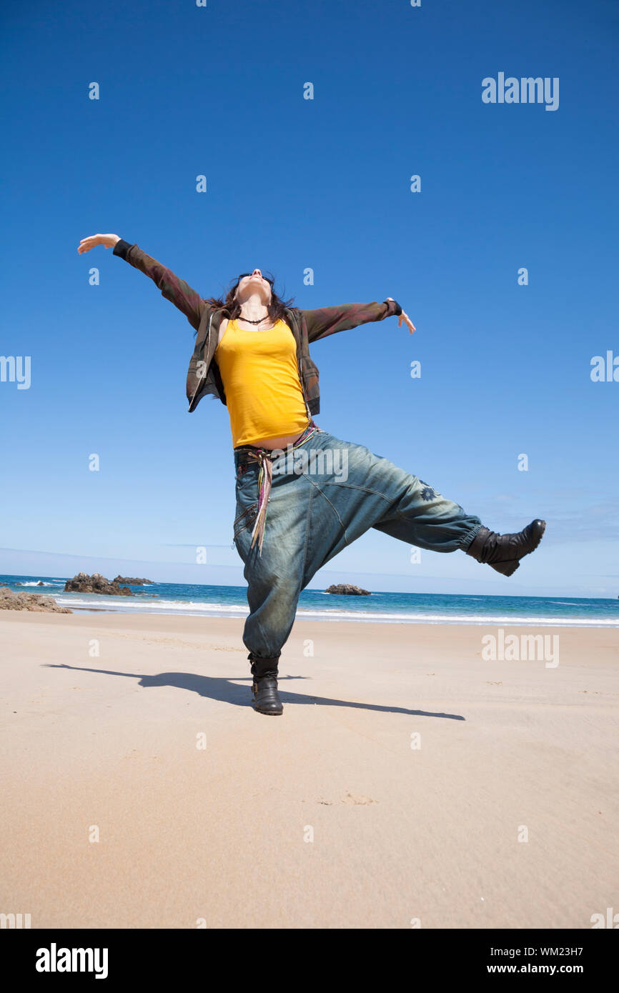 Woman dancing beach jeans hi-res stock photography and images - Alamy