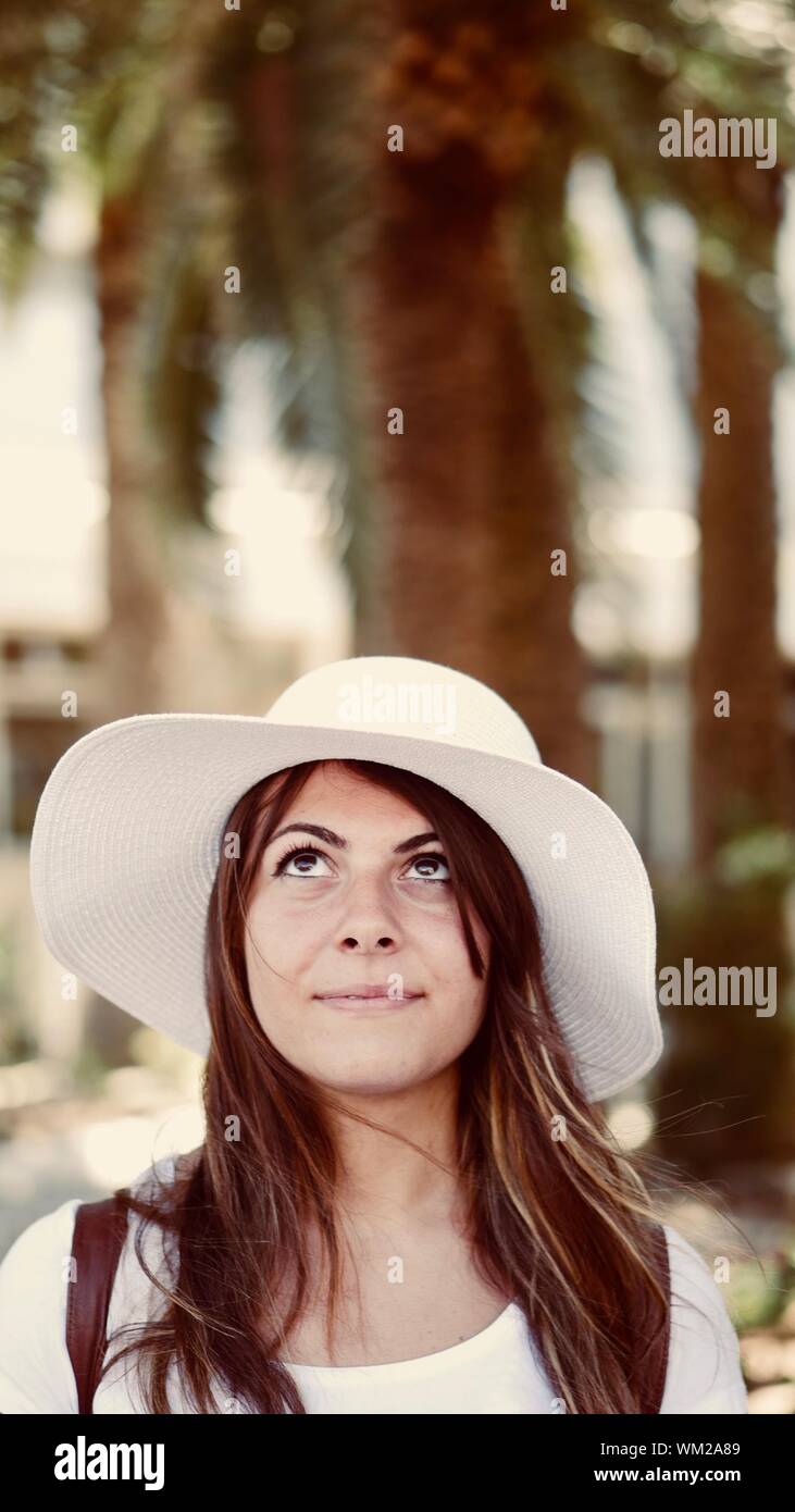 Woman Looking Up While Wearing White Hat Stock Photo