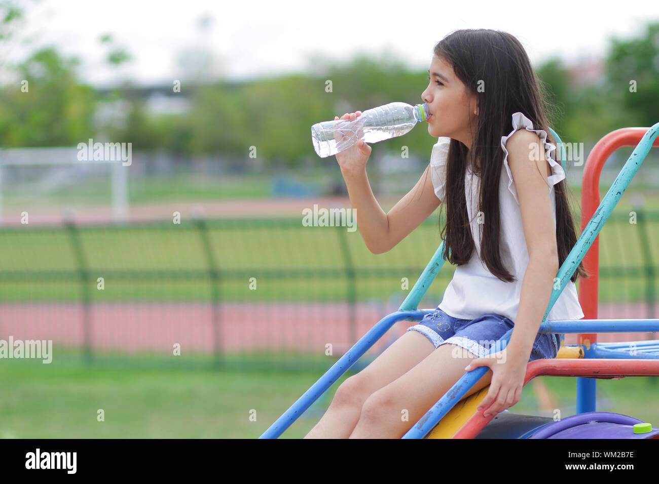 Asian girls drink bottled water Stock Photo Alamy
