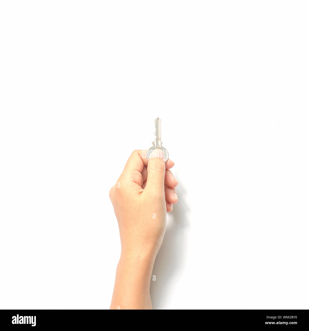 woman hand holding key on a white background Stock Photo - Alamy