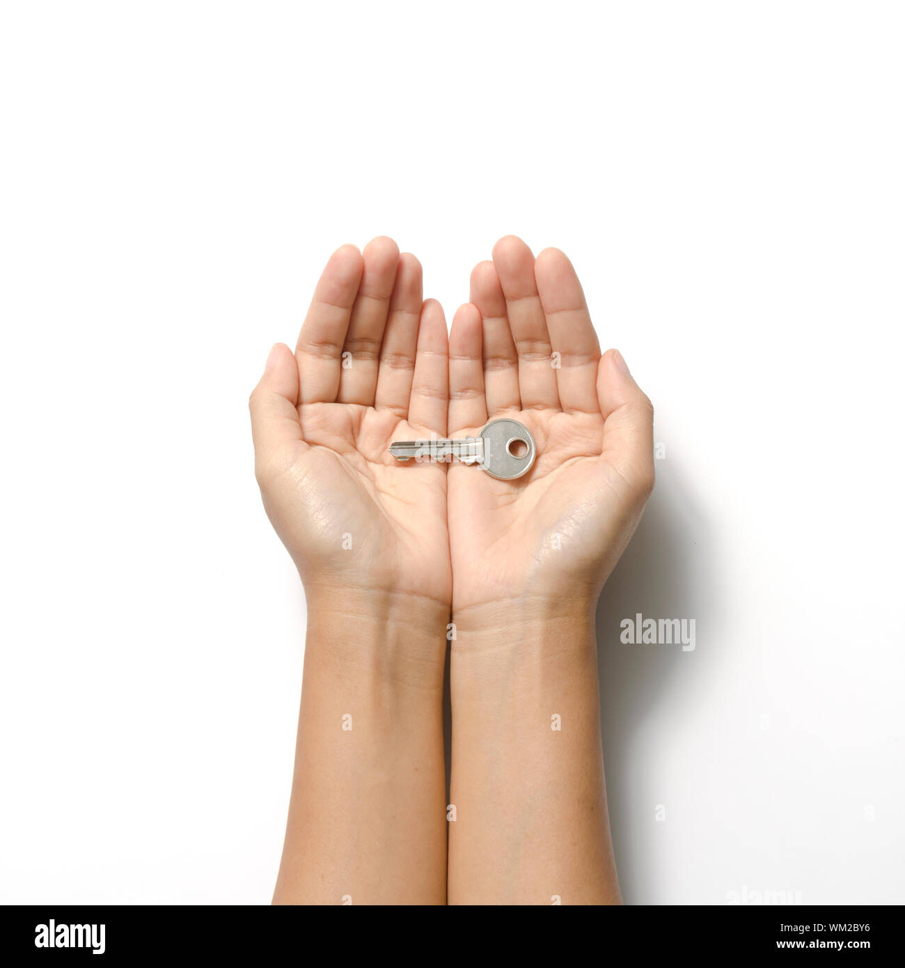 woman hand holding key on a white background Stock Photo - Alamy