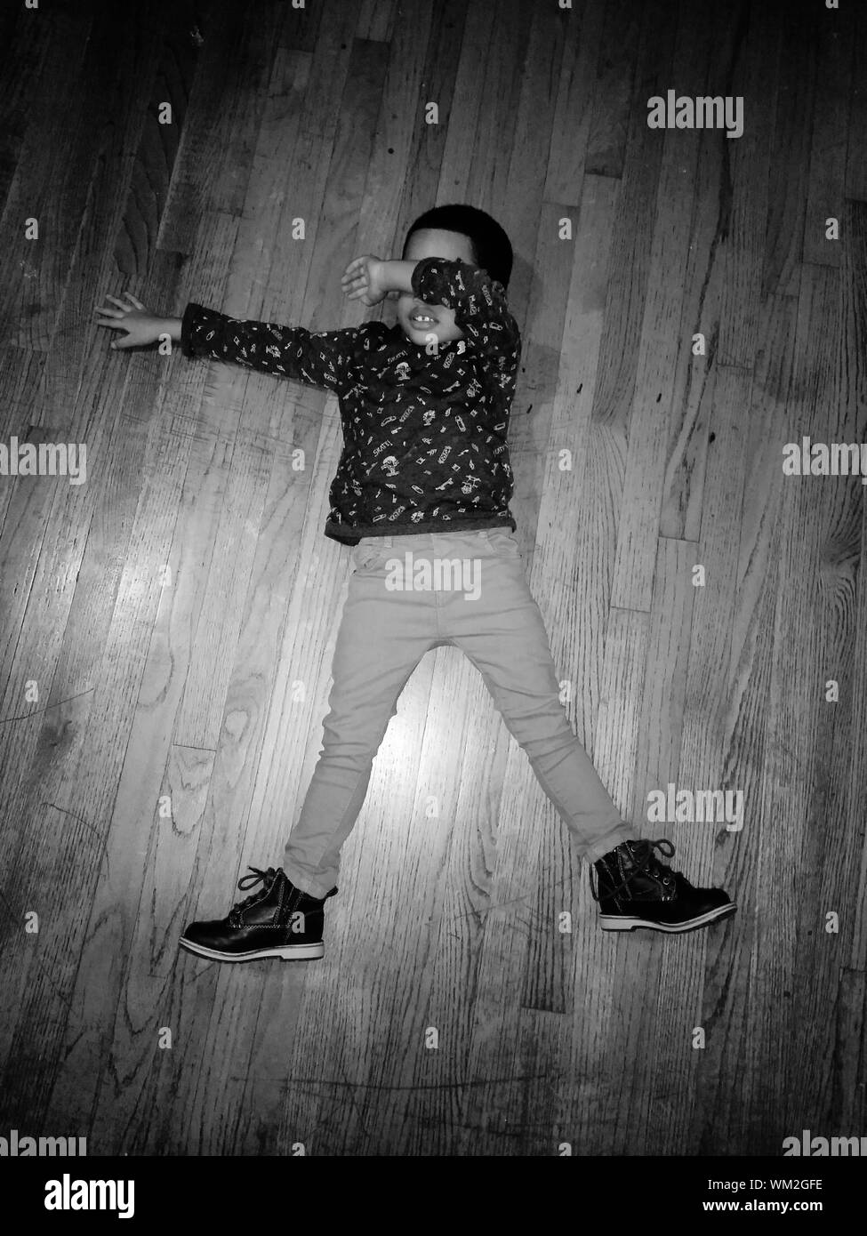 High Angle View Of Boy Sleeping On Hardwood Floor Stock Photo Alamy
