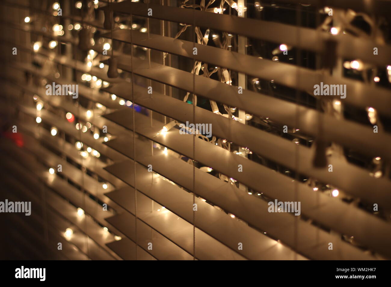 Full Frame Shot Of Illuminated Lights On Blinds Stock Photo