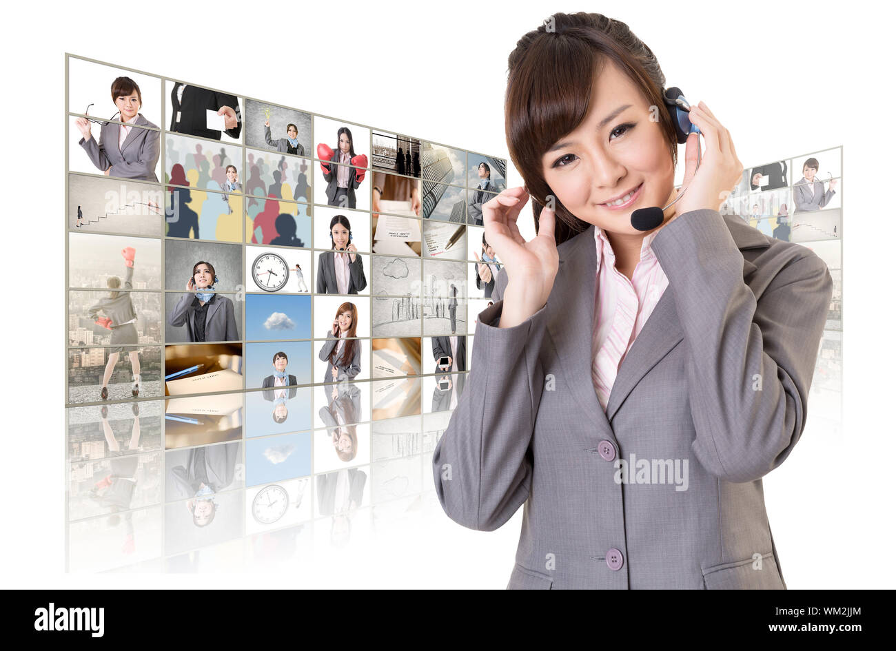 Business woman with headphone standing in front of TV screen wall. Stock Photo