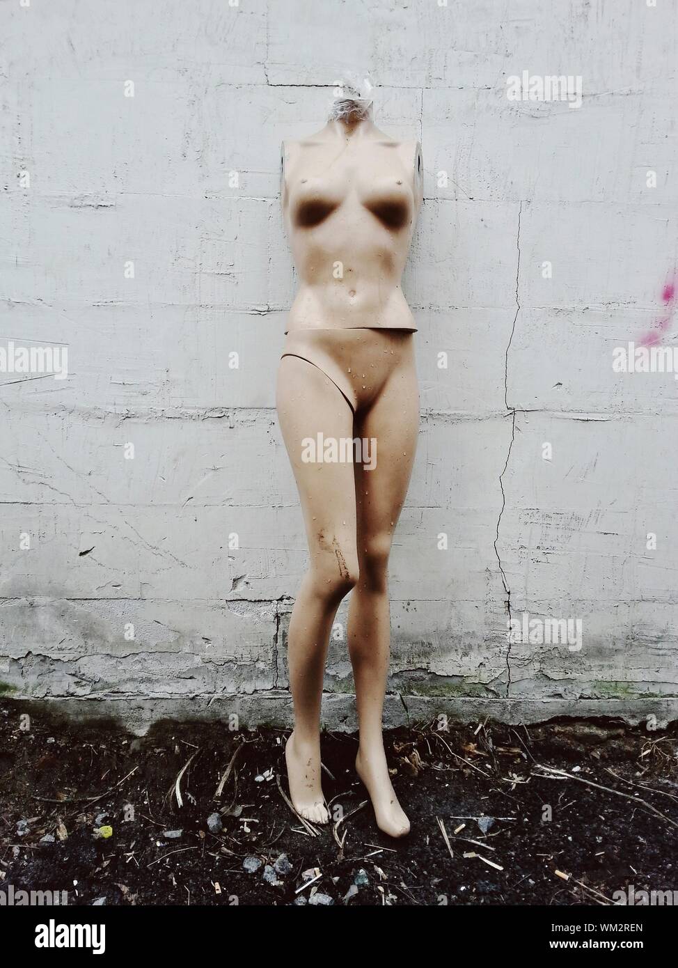 Abandoned Mannequin By Wall Stock Photo