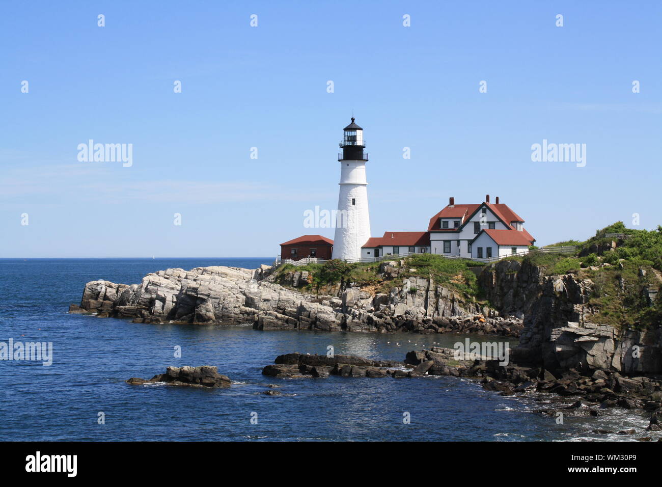 Low Angle View Of Portland Head Light By Sea Against Sky Stock Photo