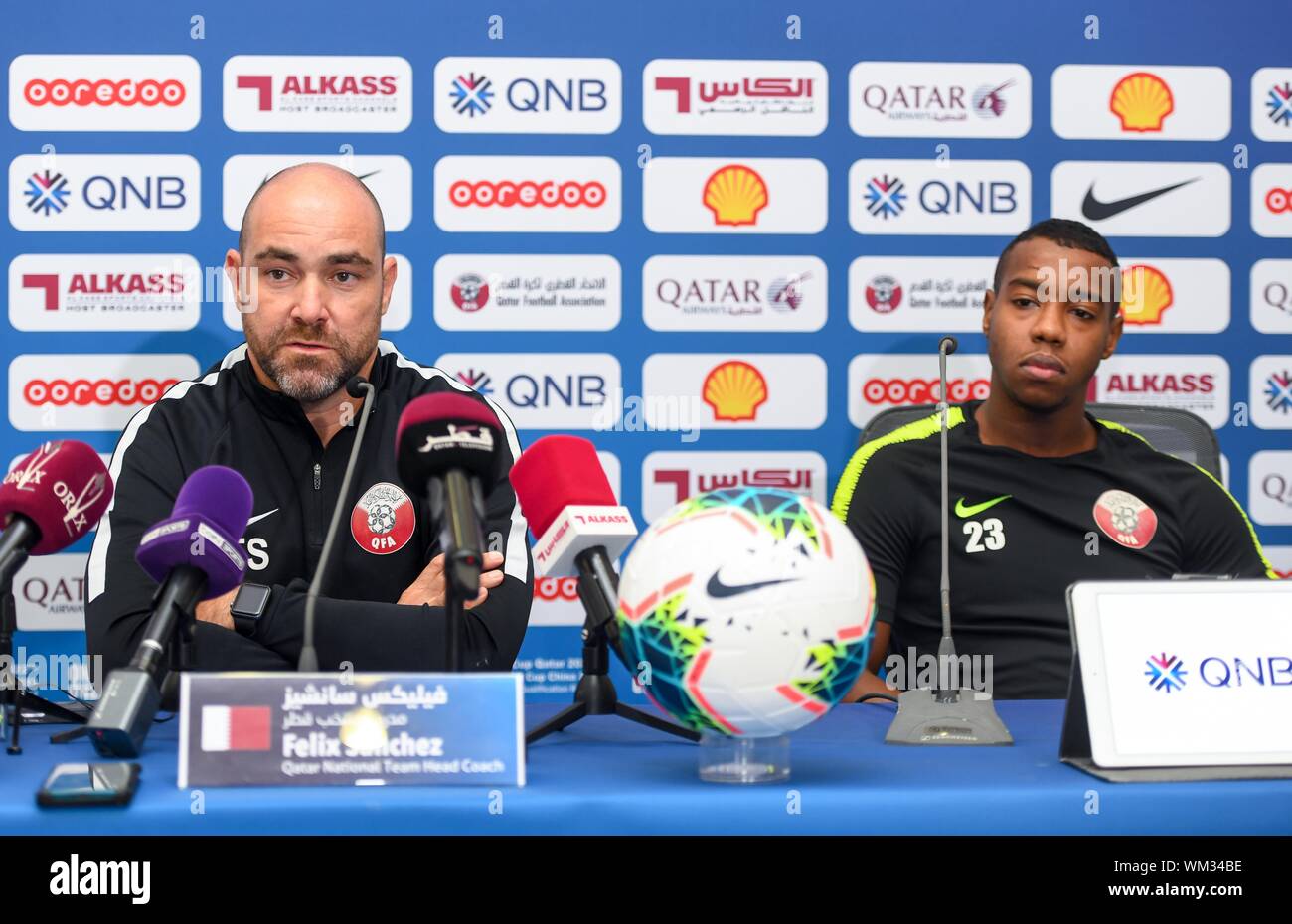 Doha, Qatar. 4th Sep, 2019. Qatar's national soccer team head coach Felix Sanchez Bas (L) and player Assim Madibo attend a press conference for the FIFA World Cup Qatar 2022 and AFC Doha, Qatar. 4th Sep, 2019. Qatar's national soccer team head coach Felix Sanchez Bas (L) and player Assim Madibo attend a press conference for the FIFA World Cup Qatar 2022 and AFC