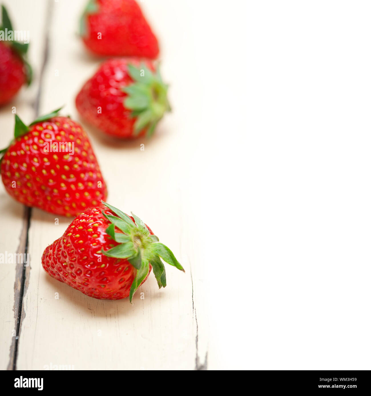 fresh organic strawberry over white wood Stock Photo - Alamy