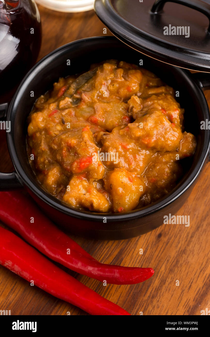 homemade hot goulash on wooden table Stock Photo
