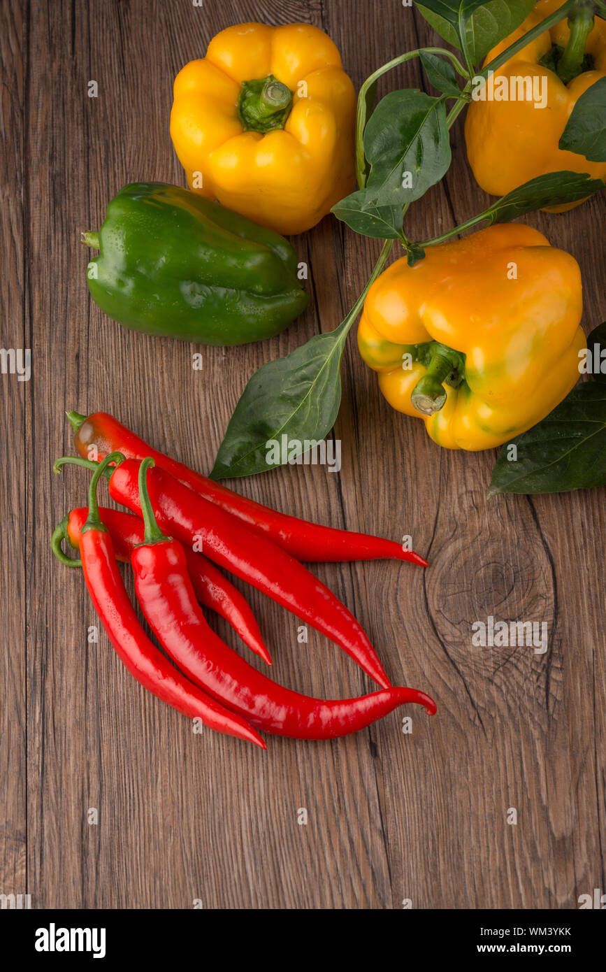 Red hot chili peppers on old wooden table Stock Photo - Alamy
