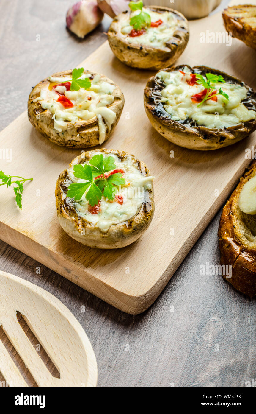 Grilled mushrooms stuffed with blue cheese and chilli and garlic toast