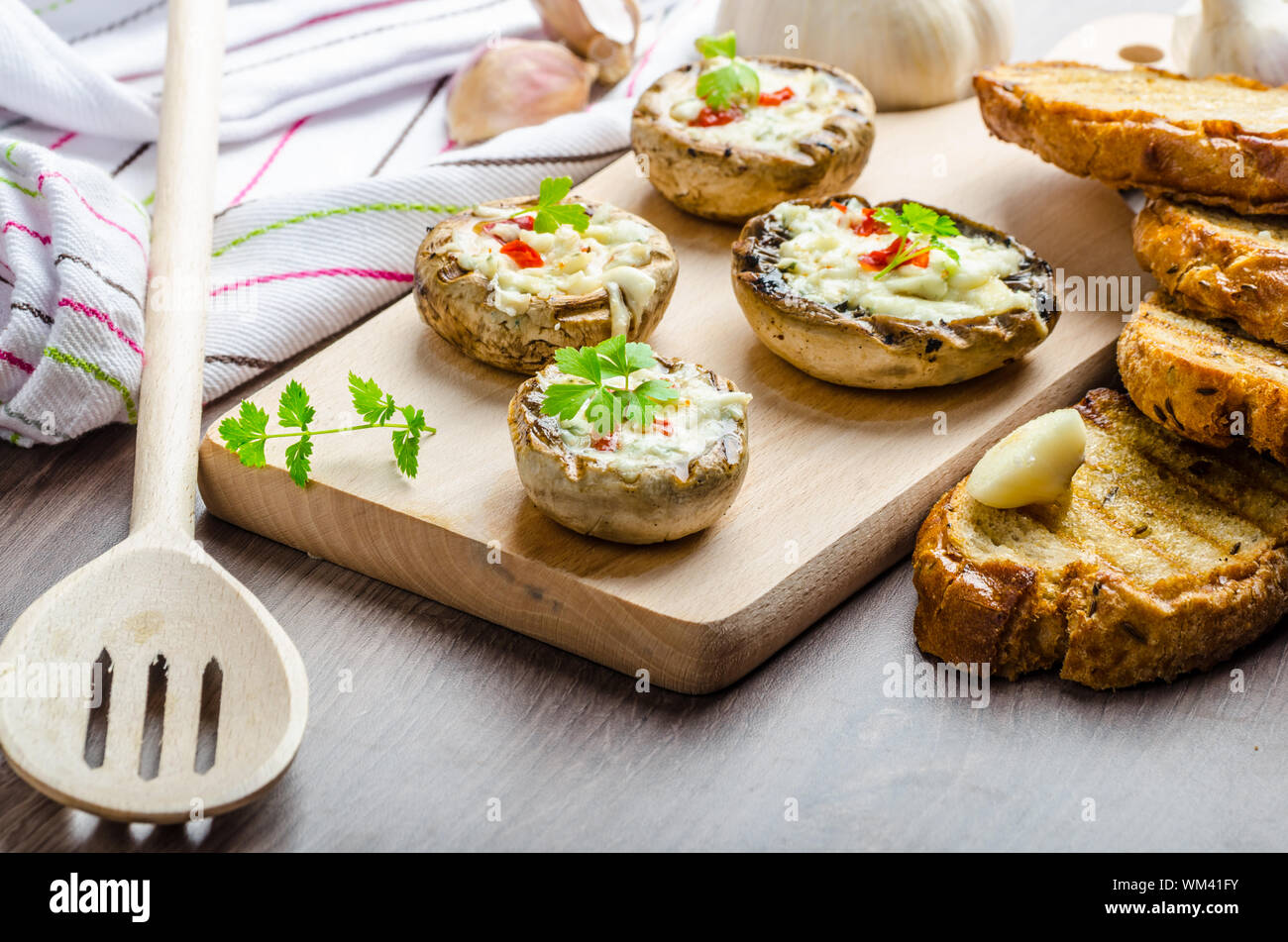 Grilled mushrooms stuffed with blue cheese and chilli and garlic toast