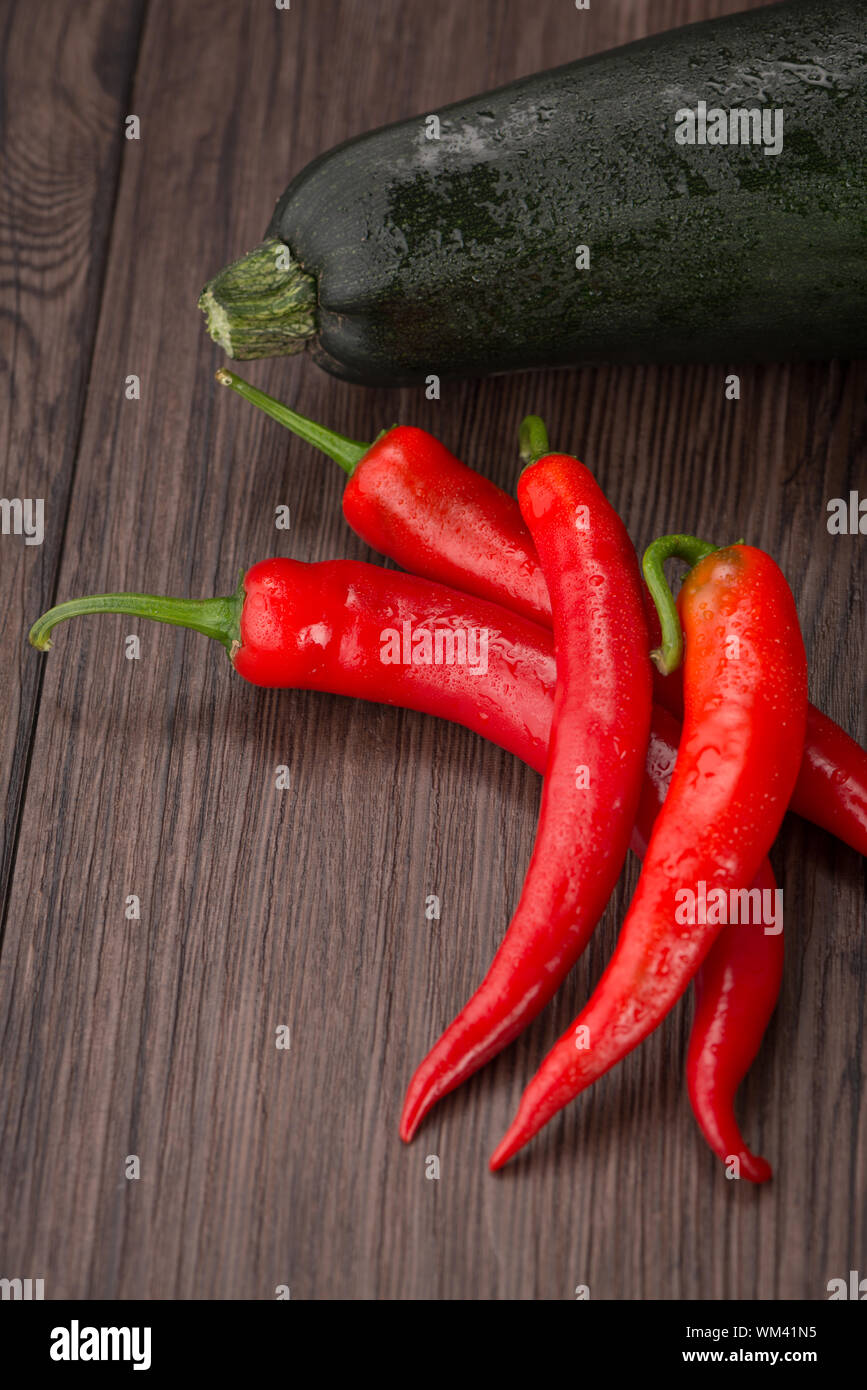 Red hot chili peppers on old wooden table Stock Photo - Alamy
