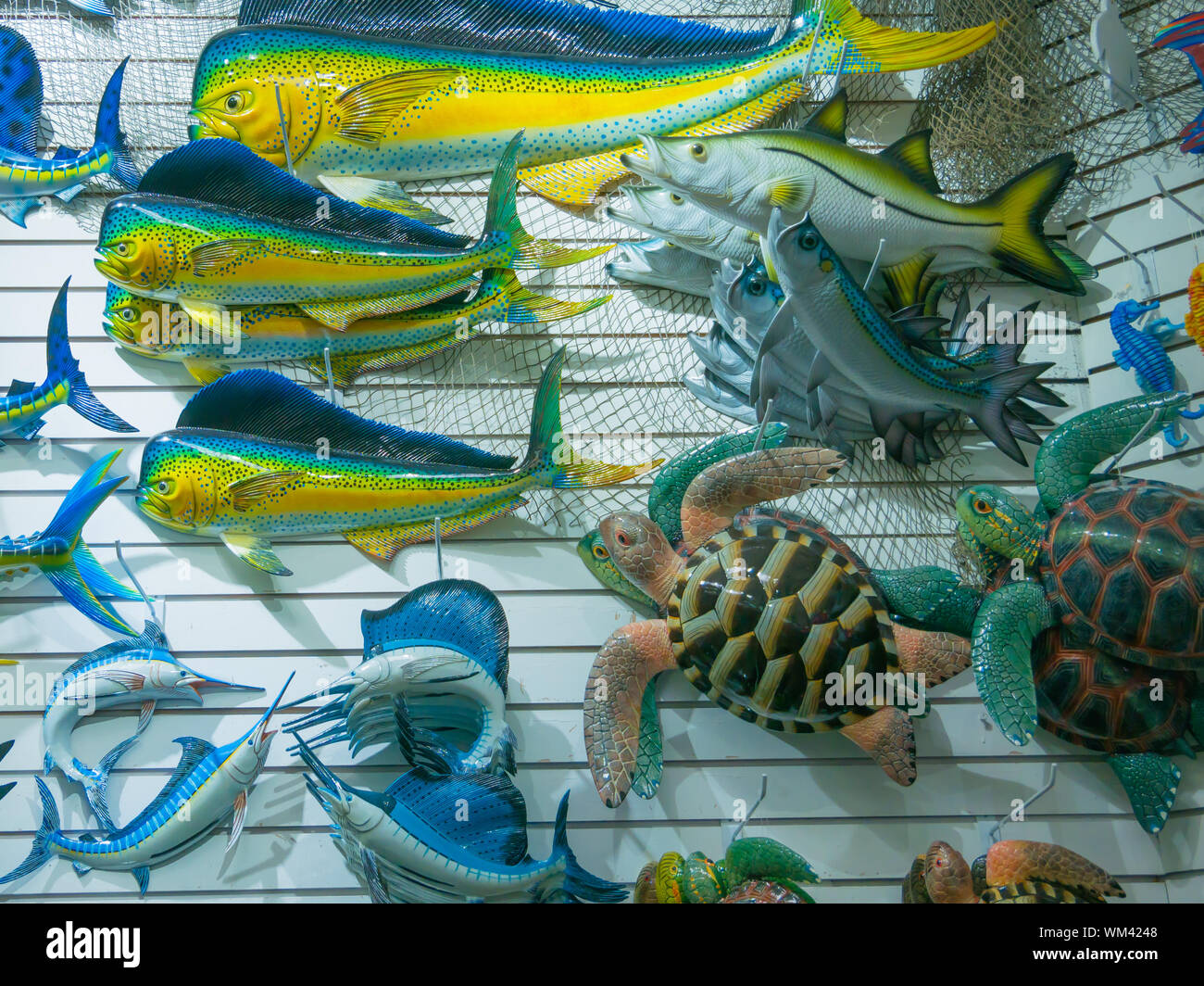 Colorful souvenir background. Hanging decoration in the market. Handmade fish hanging on the