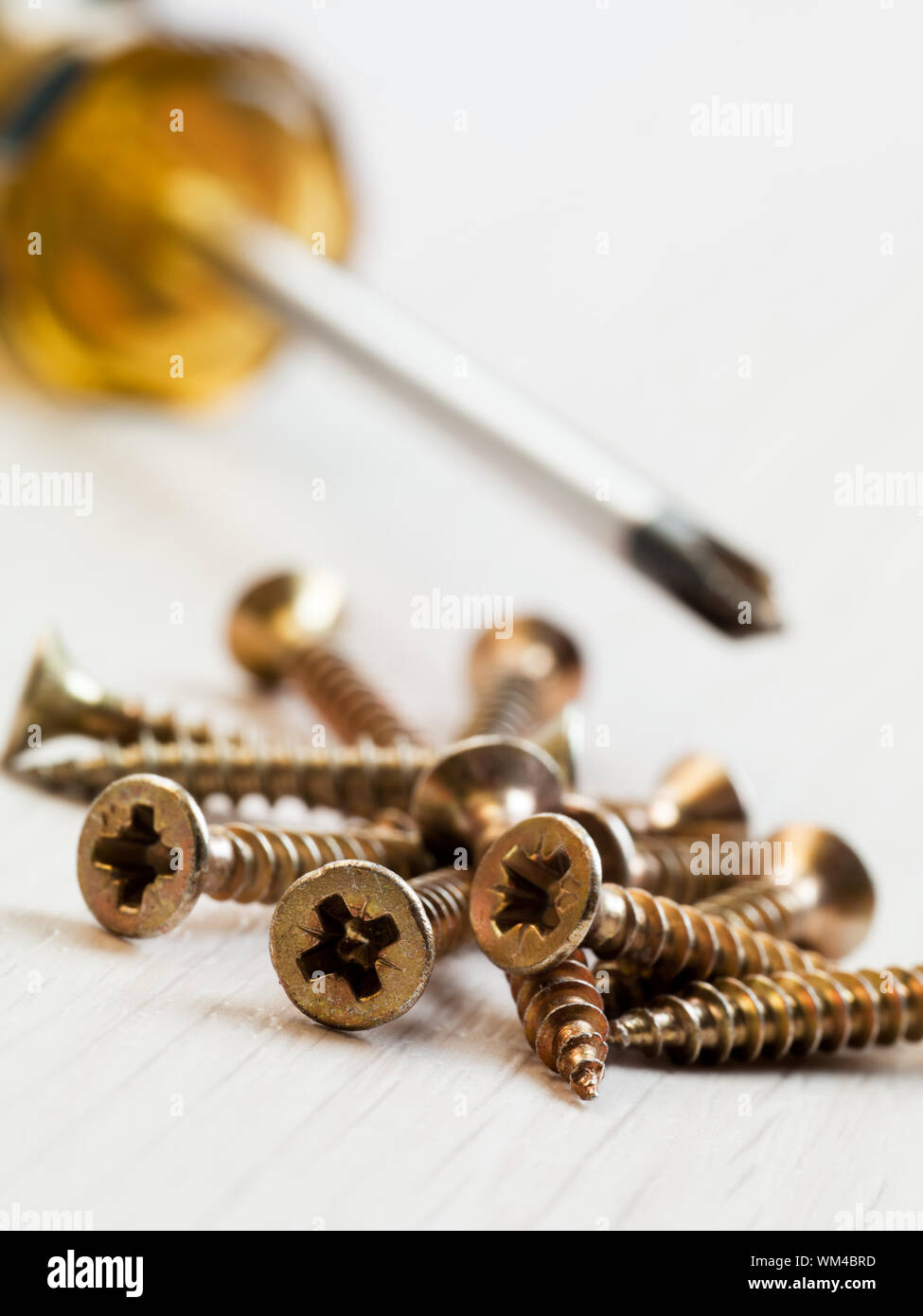 close up of screws on wooden floor. Copy space Stock Photo - Alamy