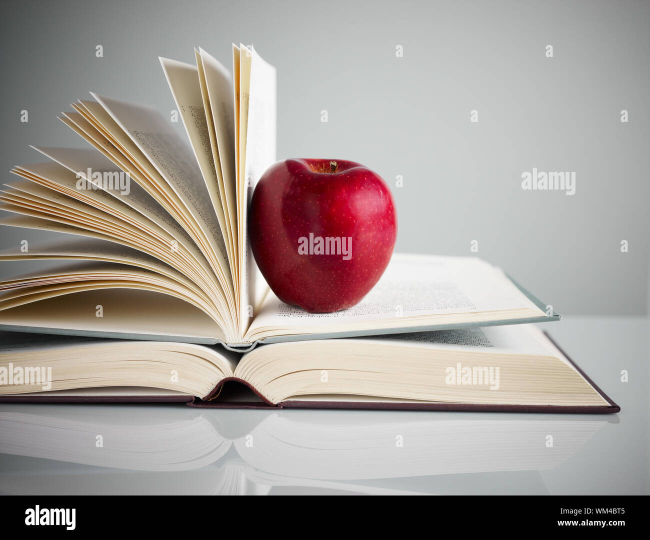 Pile Of Books And Red Apple On Desk Copy Space Stock Photo