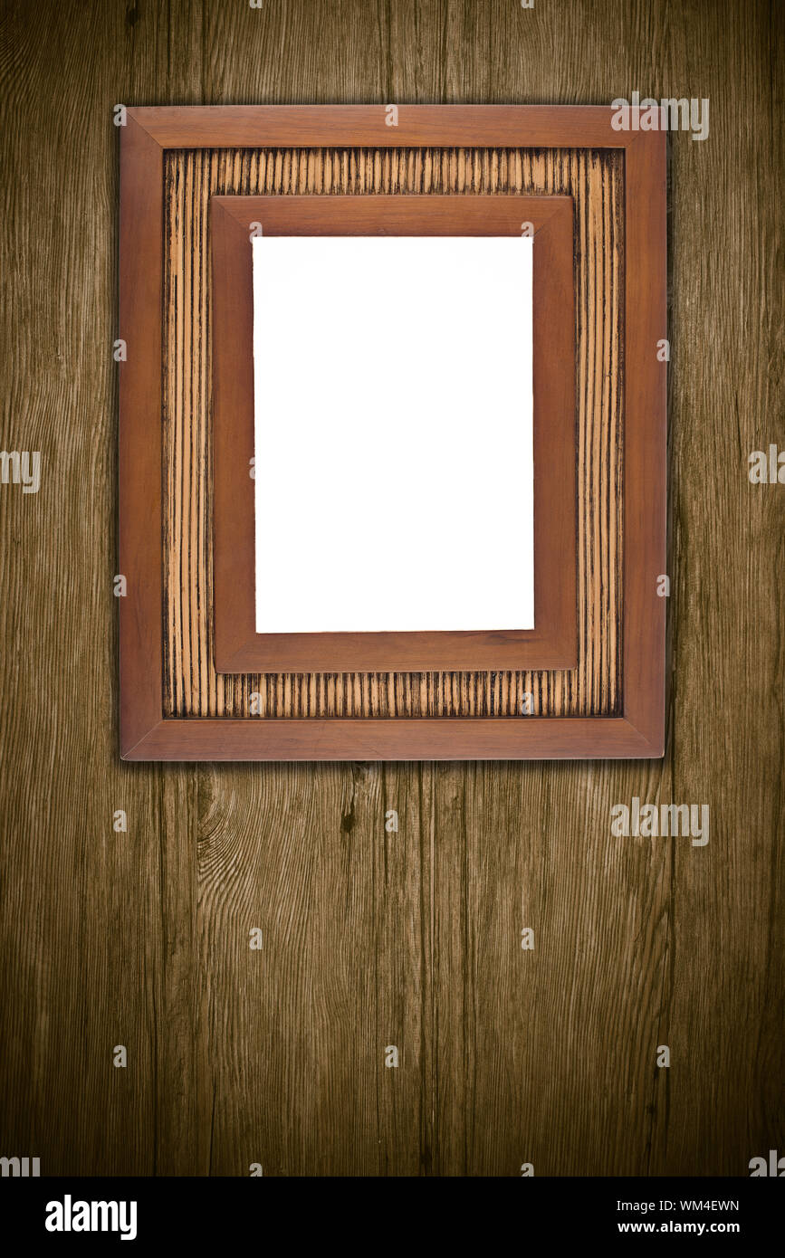 Old picture frame on vintage wood wall. Stock Photo