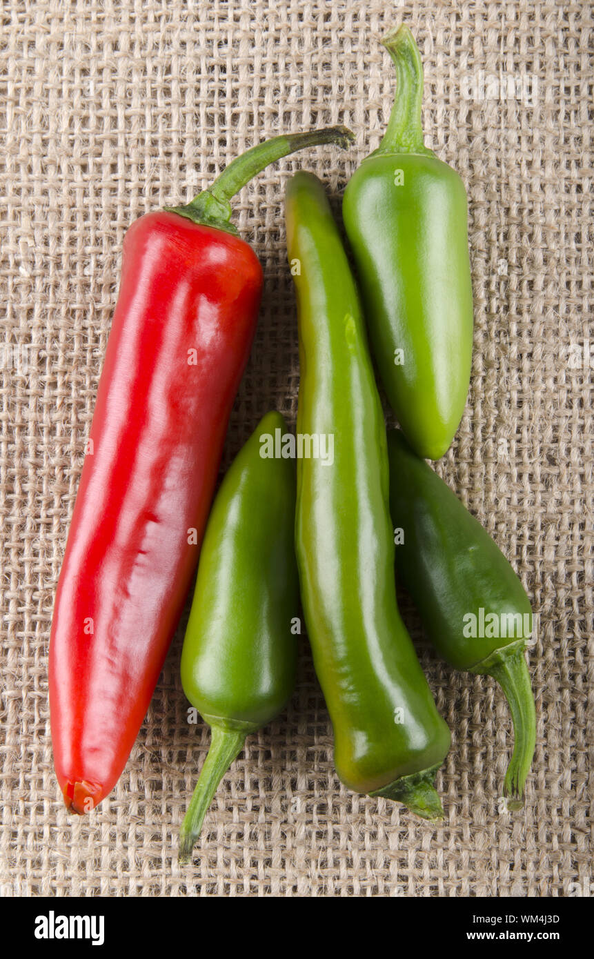 green and red chili pepper on jute Stock Photo - Alamy