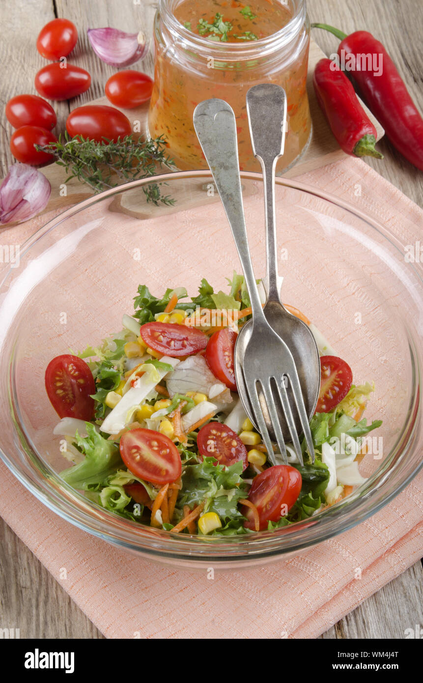 mixed salad in a glass bowl with vinaigrette Stock Photo - Alamy