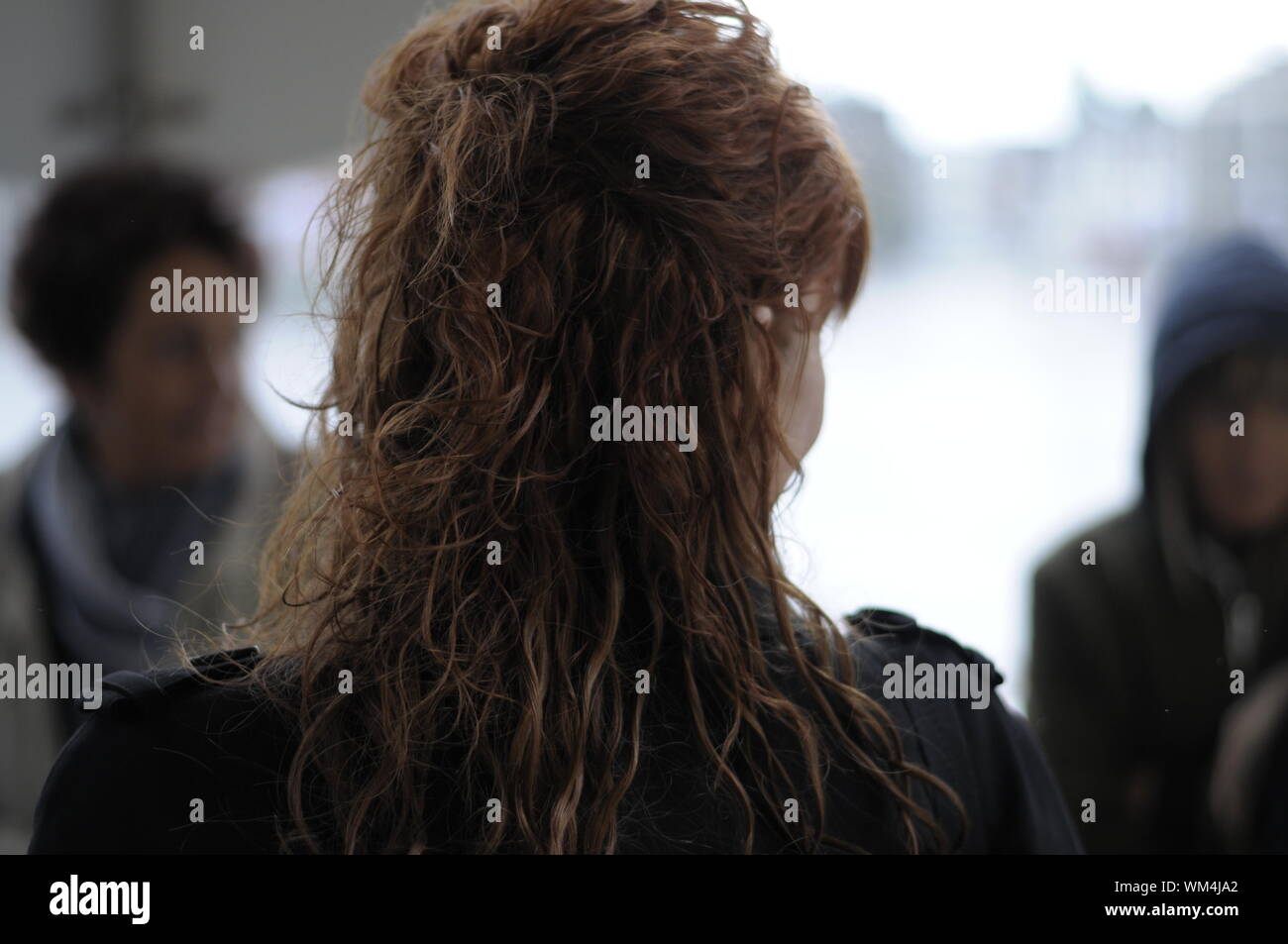 Rear View Of Woman With Wavy Hair Stock Photo