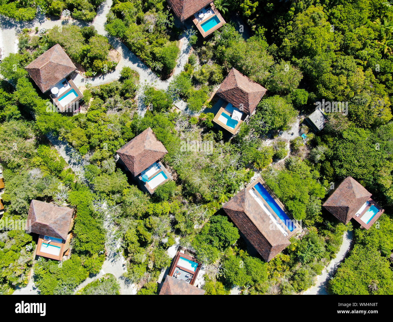 Aerial view of luxury villa with swimming pool in tropical forest ...