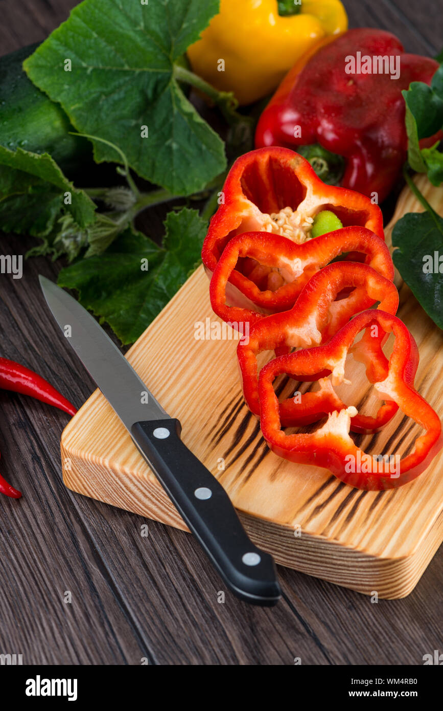 Colored bell peppers on old wooden table Stock Photo - Alamy