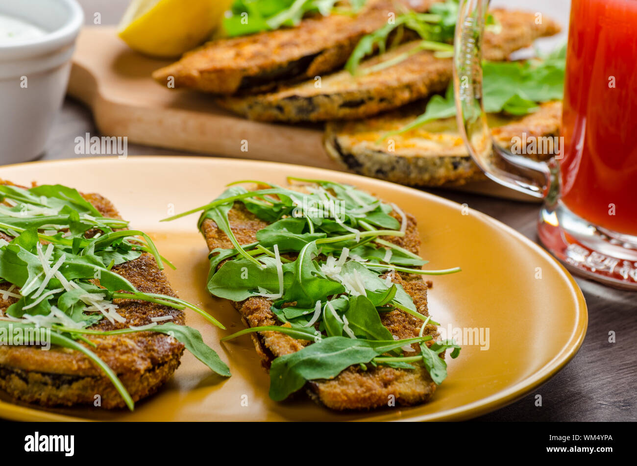 Breaded eggplant parmesan and arugula, fresh limonade from red orange