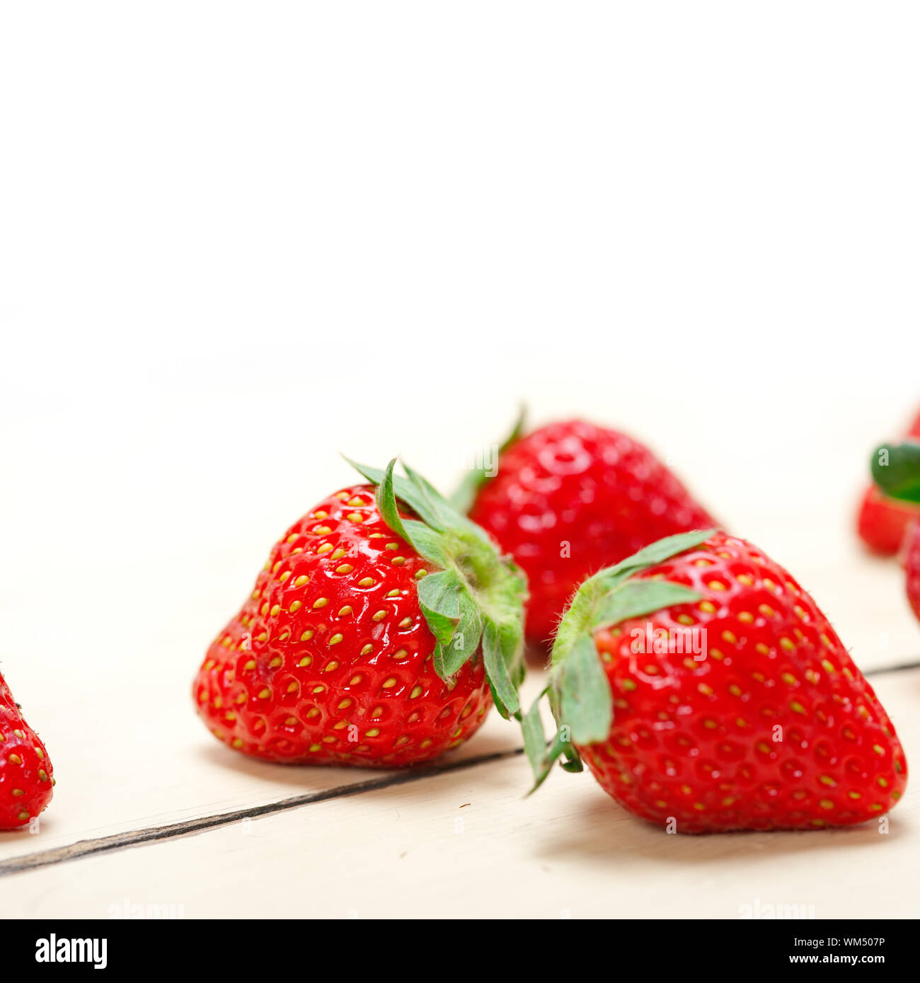 fresh organic strawberry over white wood Stock Photo - Alamy