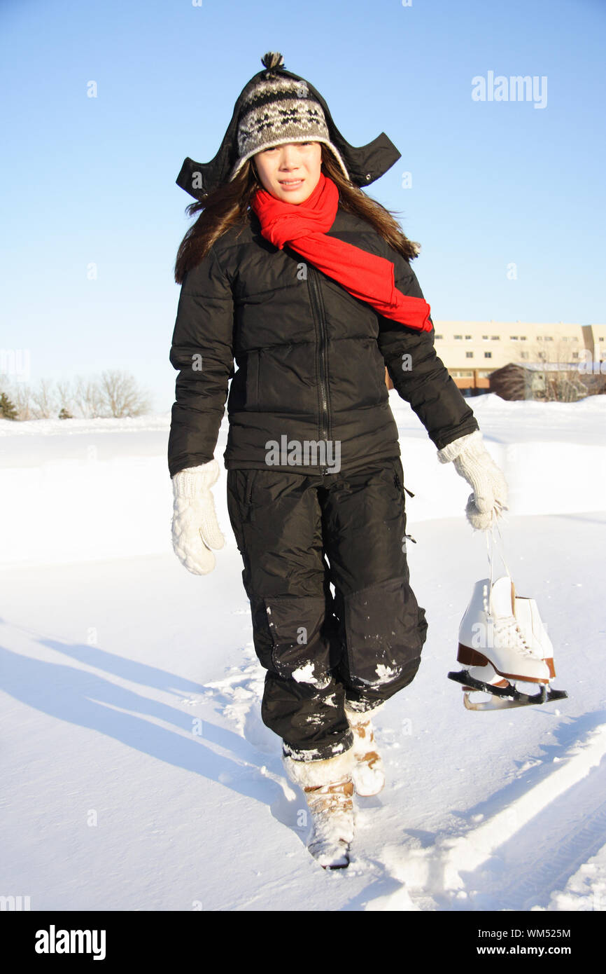 Ice skating. Woman walking with figure skating ice skates outdoors in