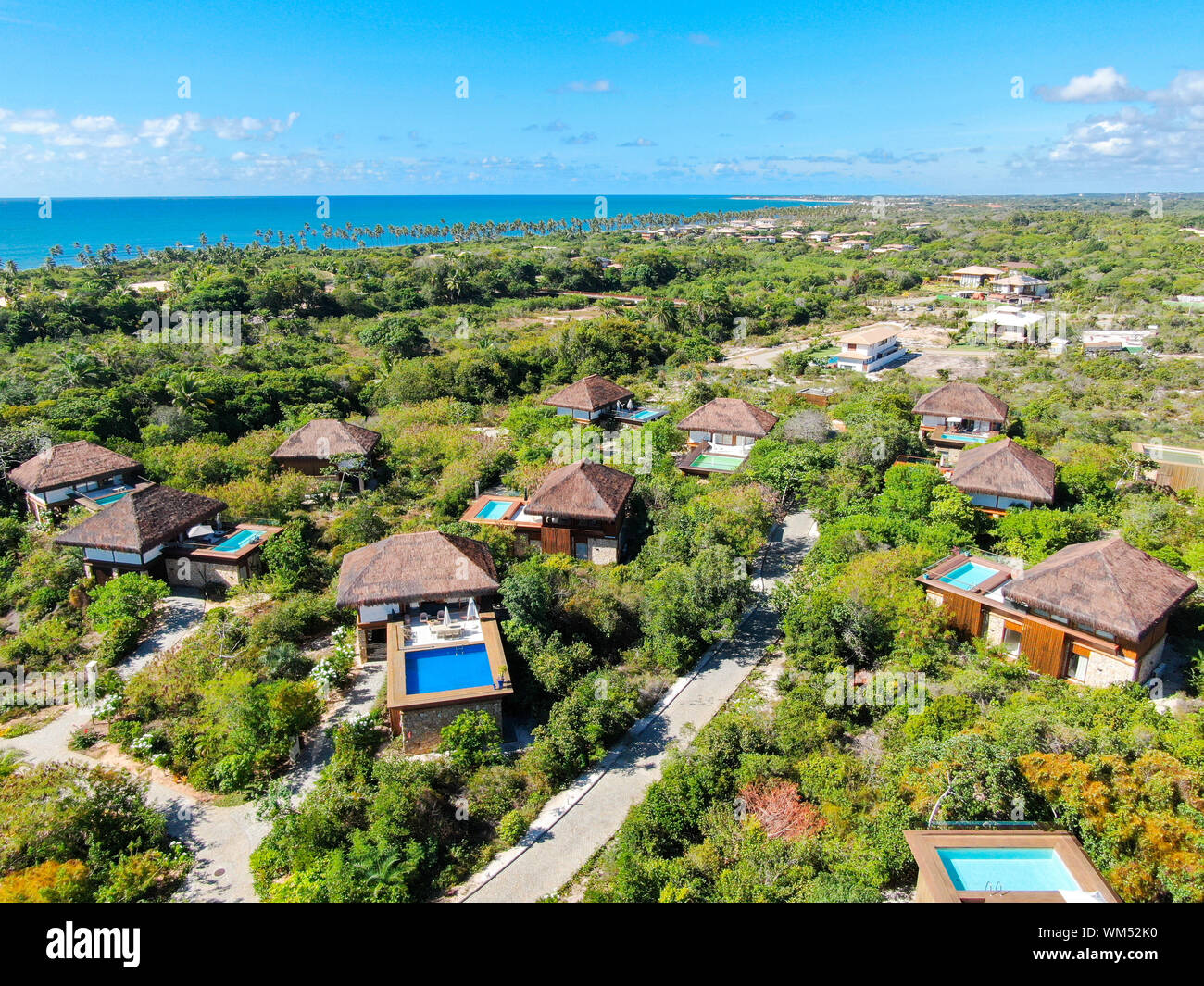 View of Aerial view of luxury villa with swimming pool in tropical forest ...