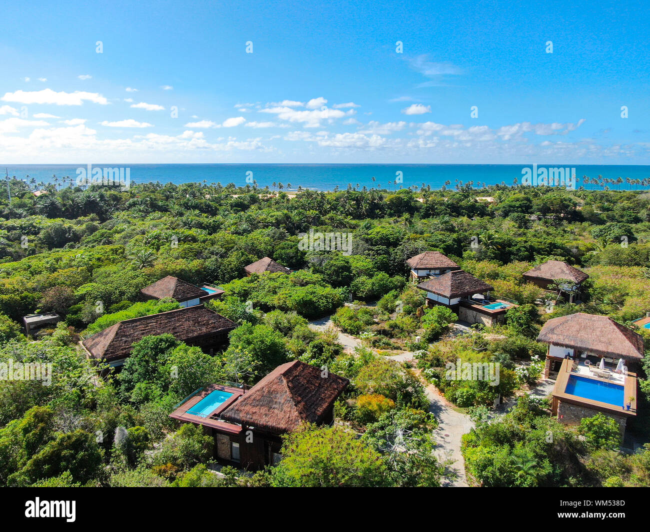 View of Aerial view of luxury villa with swimming pool in tropical forest ...