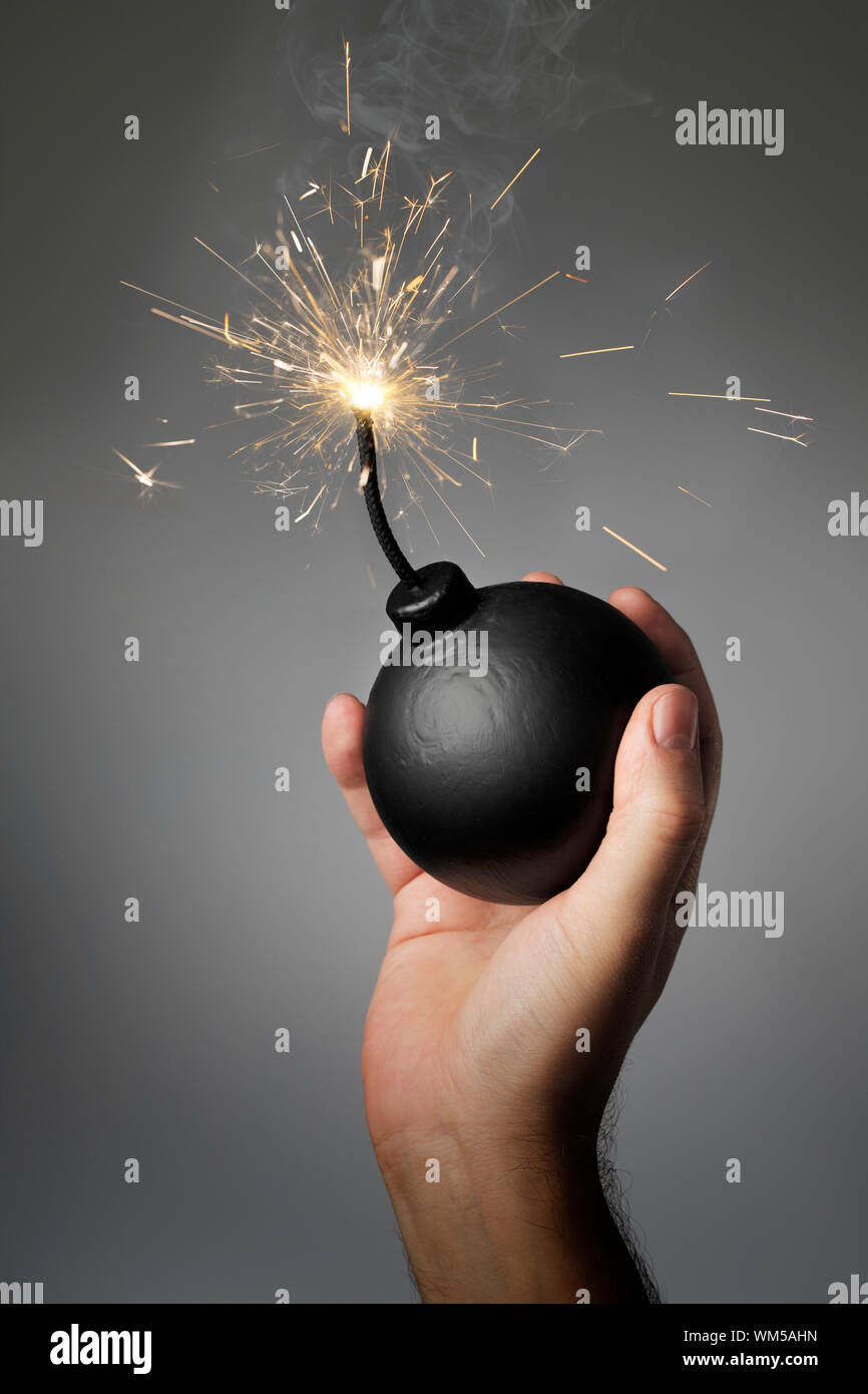 Man throwing an old-style (fake) bomb Stock Photo - Alamy