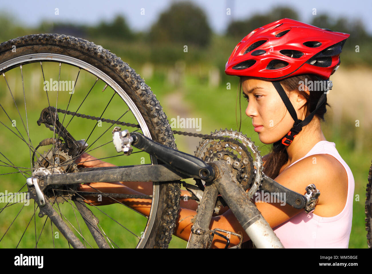 Bike repair. Woman repairing mountain bike Stock Photo Alamy