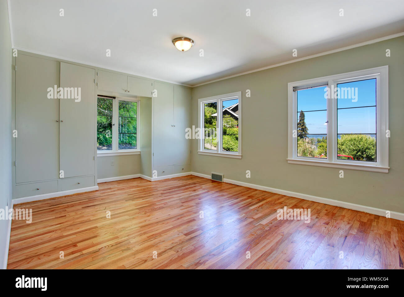 Empty Master Bedroom Interior With Windows Hardwood Floor