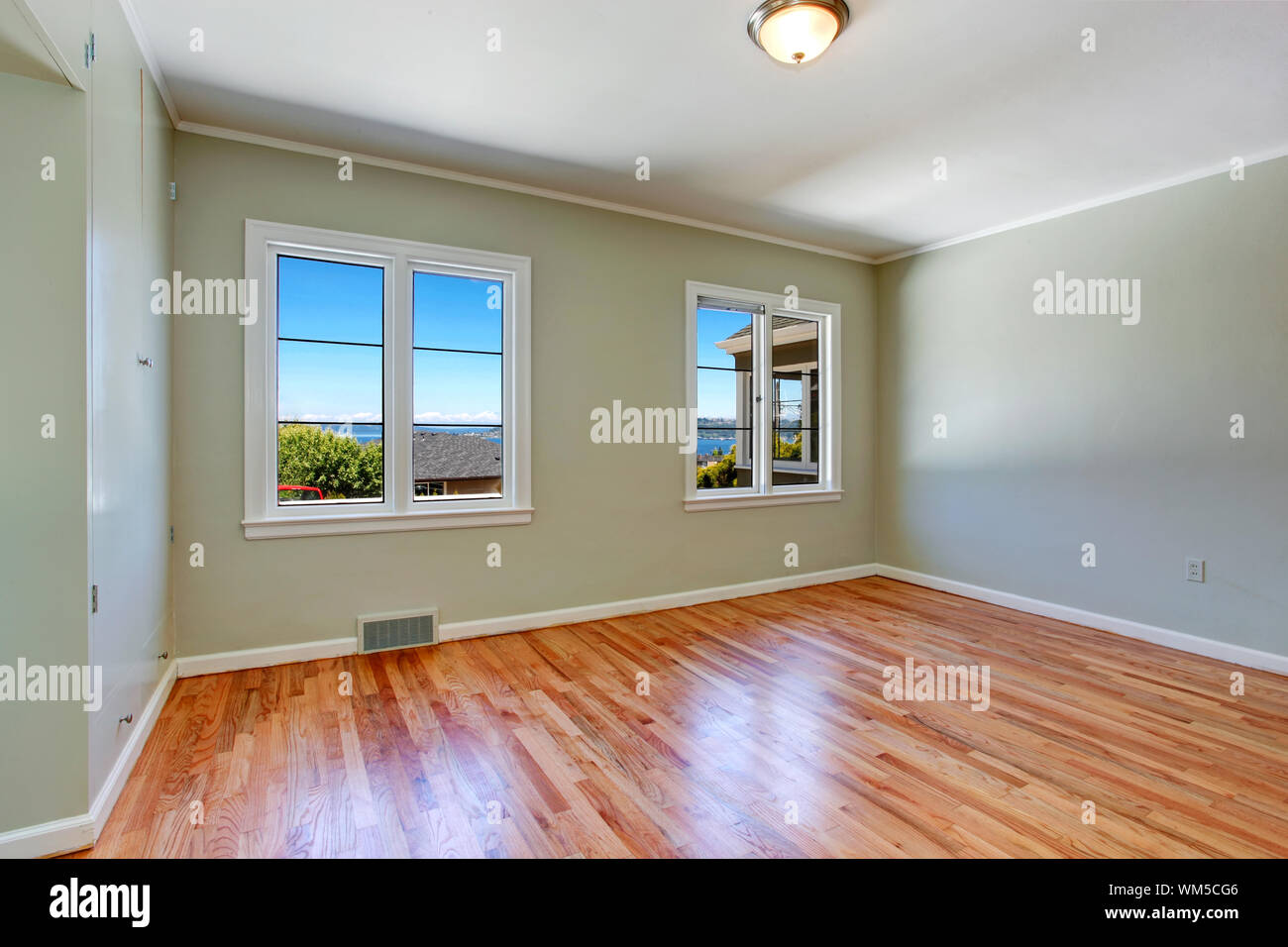 Empty Master Bedroom Interior With Windows And Hardwood