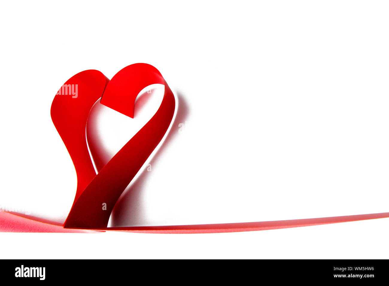 Heart from red ribbon isolated on white background Stock Photo - Alamy