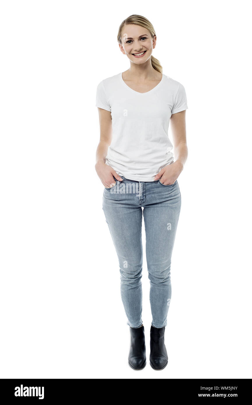 Pretty woman standing with hands in pockets Stock Photo - Alamy