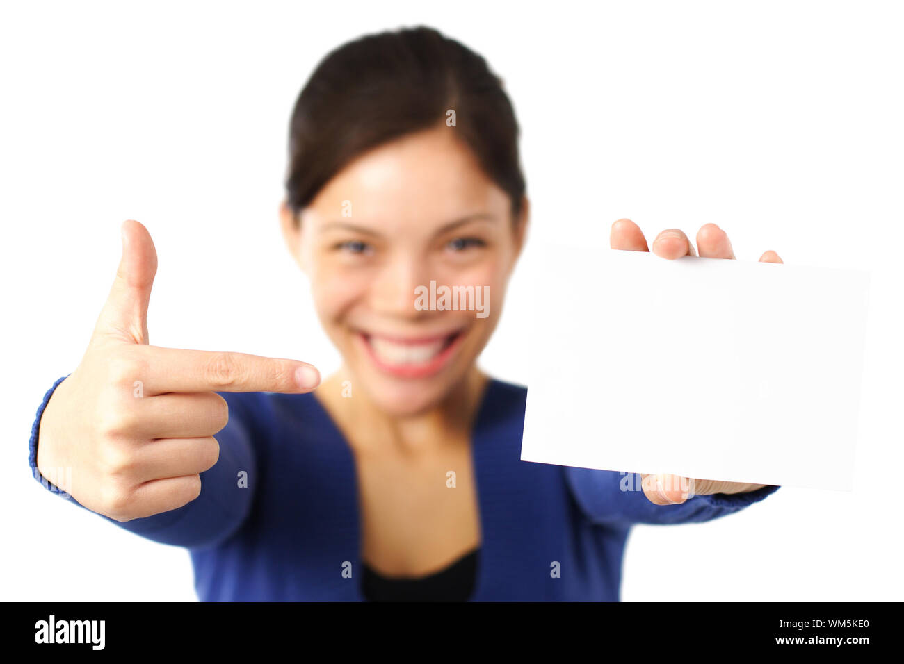 Pointing at blank paper card. very happy excited woman pointing at