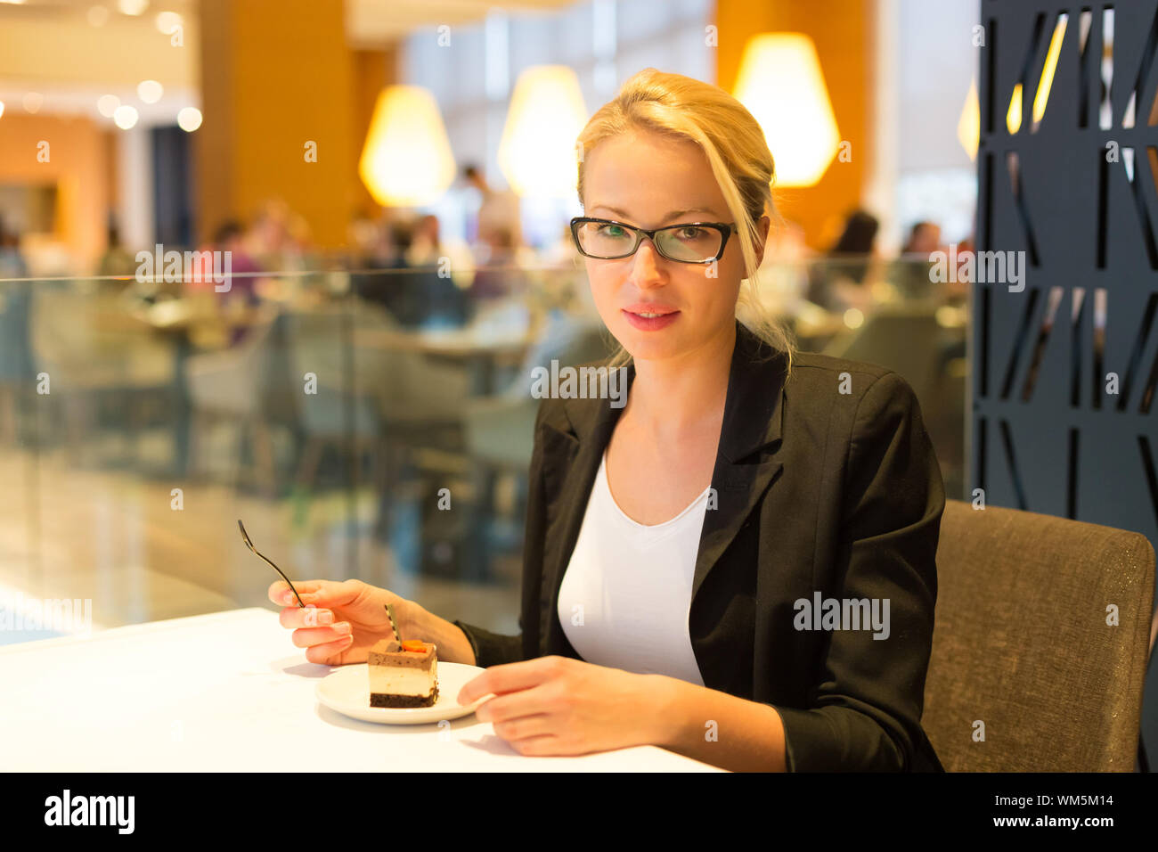 Women eating dessert in fancy restaurant Stock Photo - Alamy