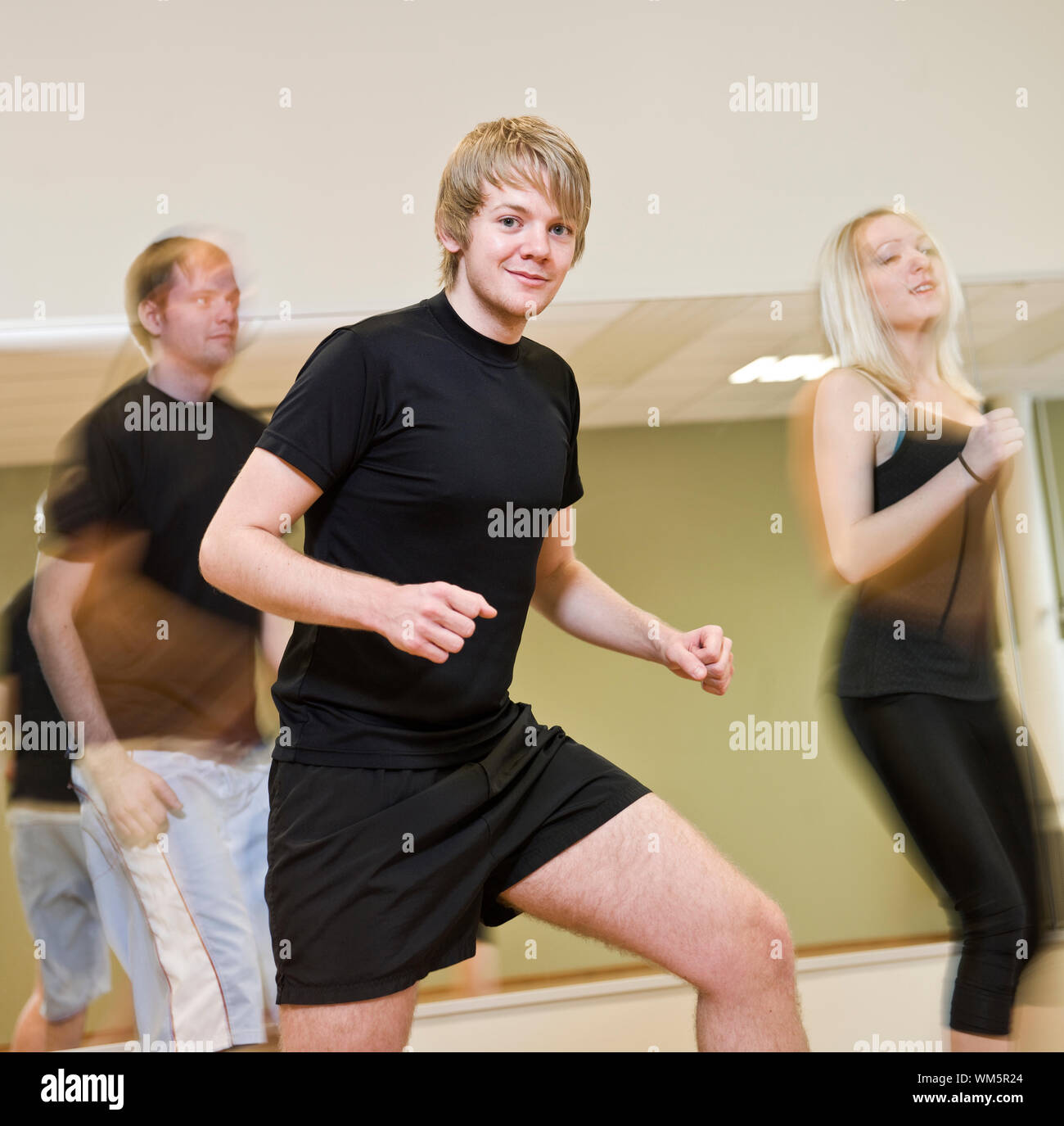 Group of people doing step up with a boy in focus Stock Photo - Alamy