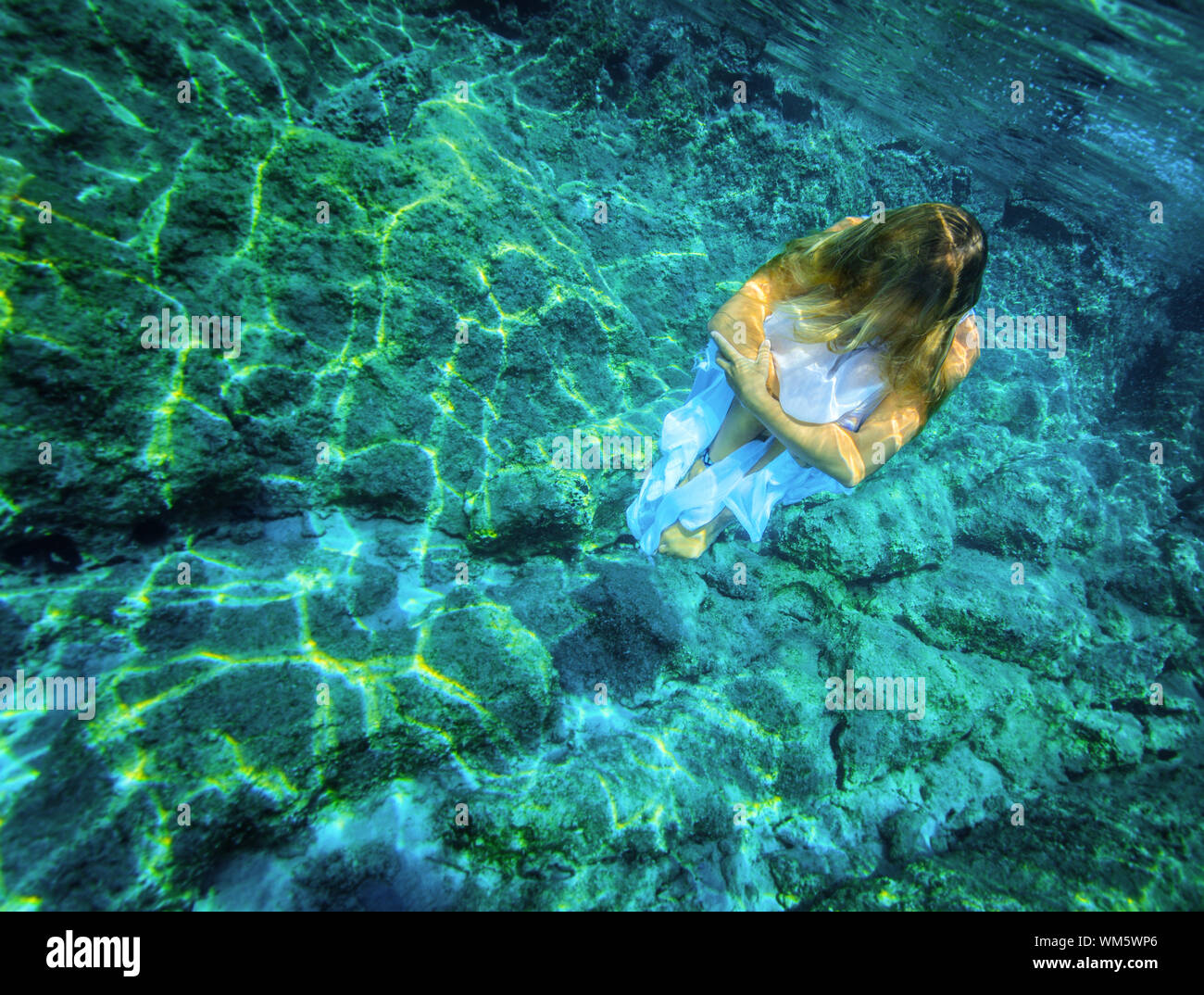 Underwater meditating Stock Photo