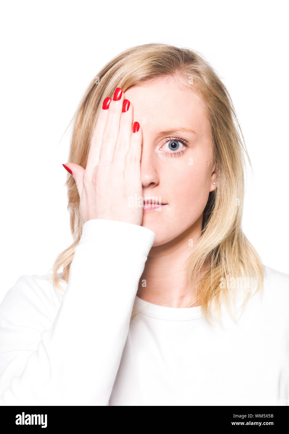 Young woman covering her face isolated a white background Stock Photo