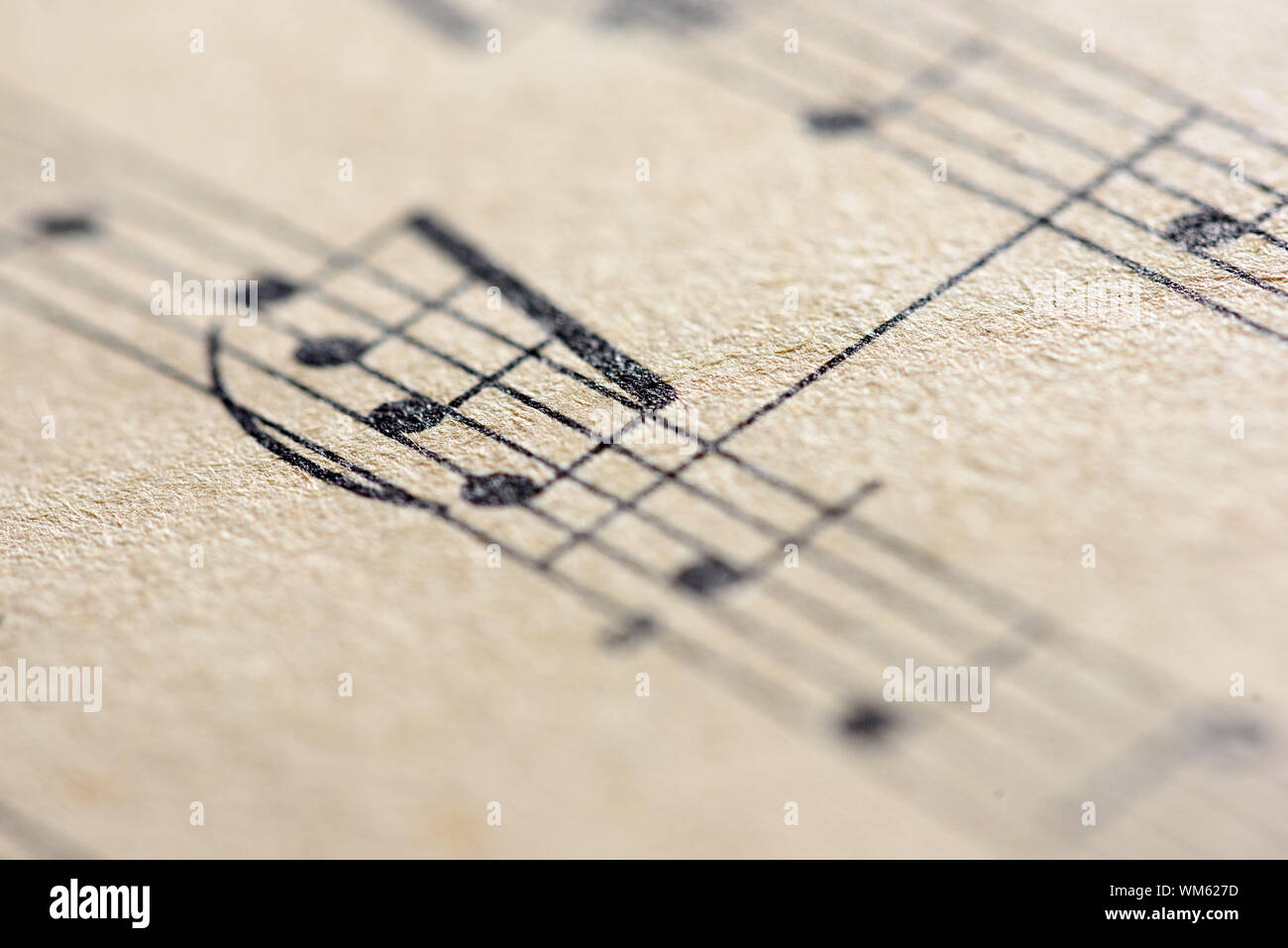 Aged sepia effect of a macro closeup shot of musical notes written on paper notes in traditional sheet music format Stock Photo