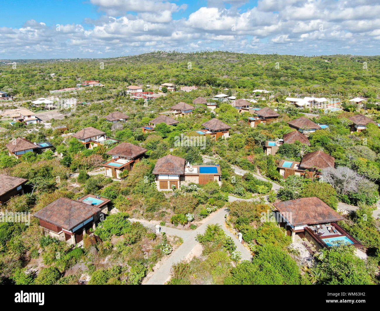 Aerial view of luxury villa with swimming pool in tropical forest. Private tropical villa with swimming pool among tropical garden with palm trees Stock Photo