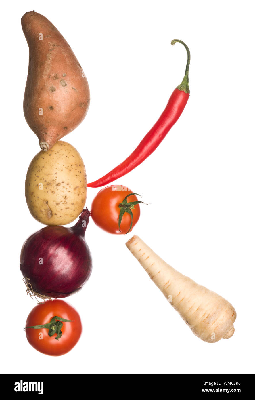 The letter 'K' made out of vegetables isolated on a white background ...