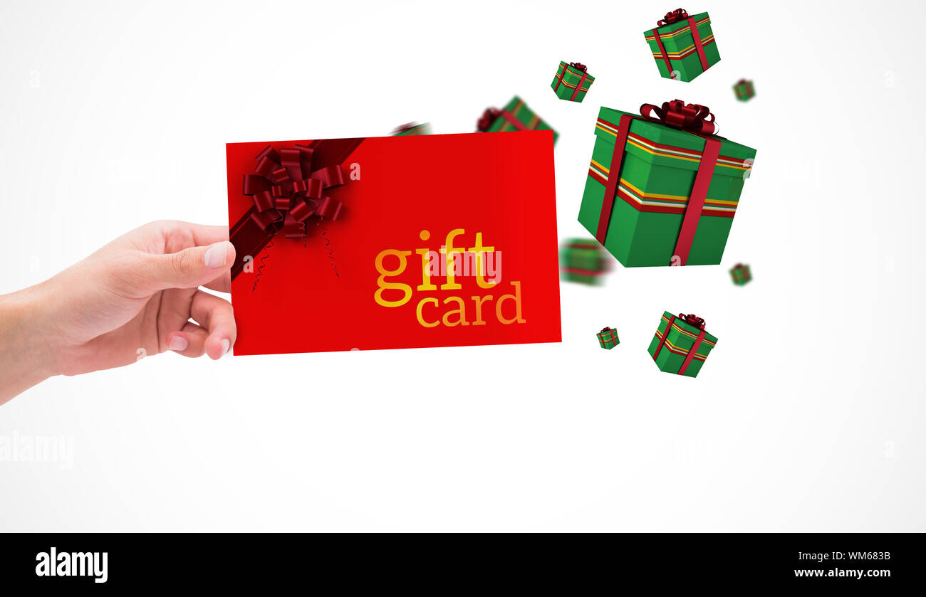 Hand holding card against gift card with festive bow Stock Photo - Alamy
