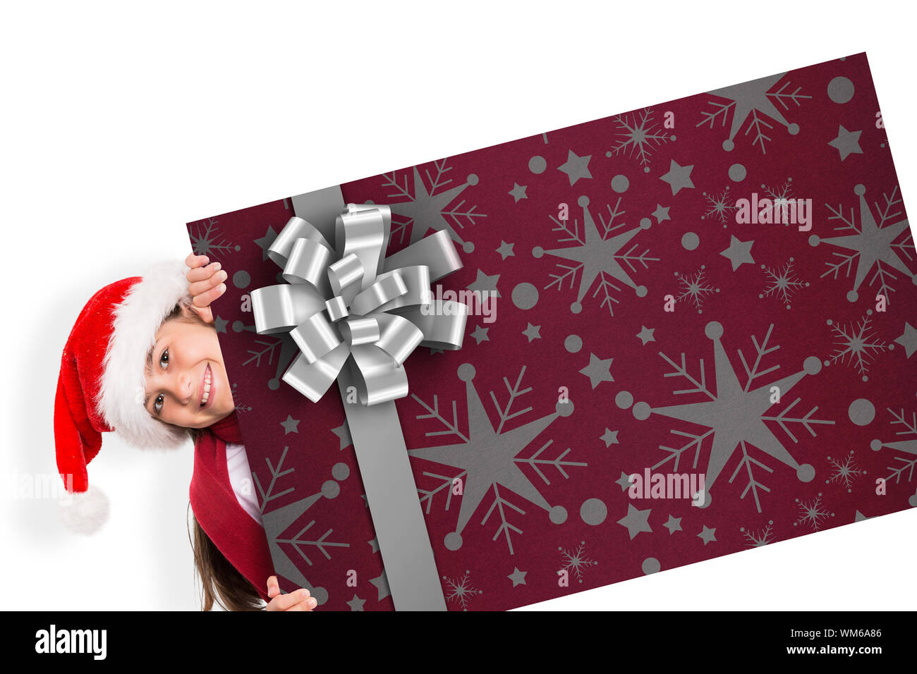 Festive little girl showing card against christmas wrapping paper with bow Stock Photo - Alamy