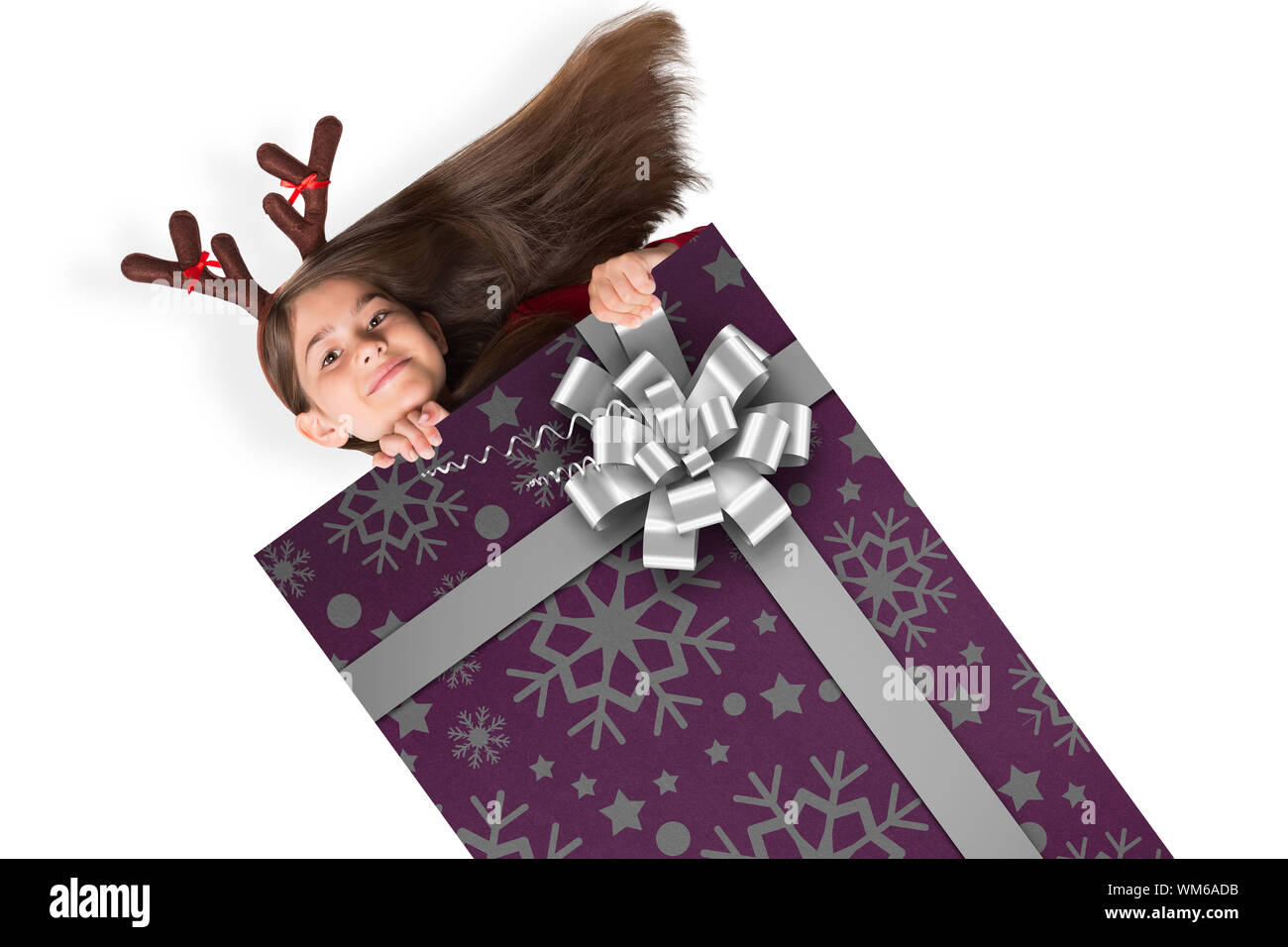 Festive little girl showing card against christmas wrapping paper with bow Stock Photo - Alamy