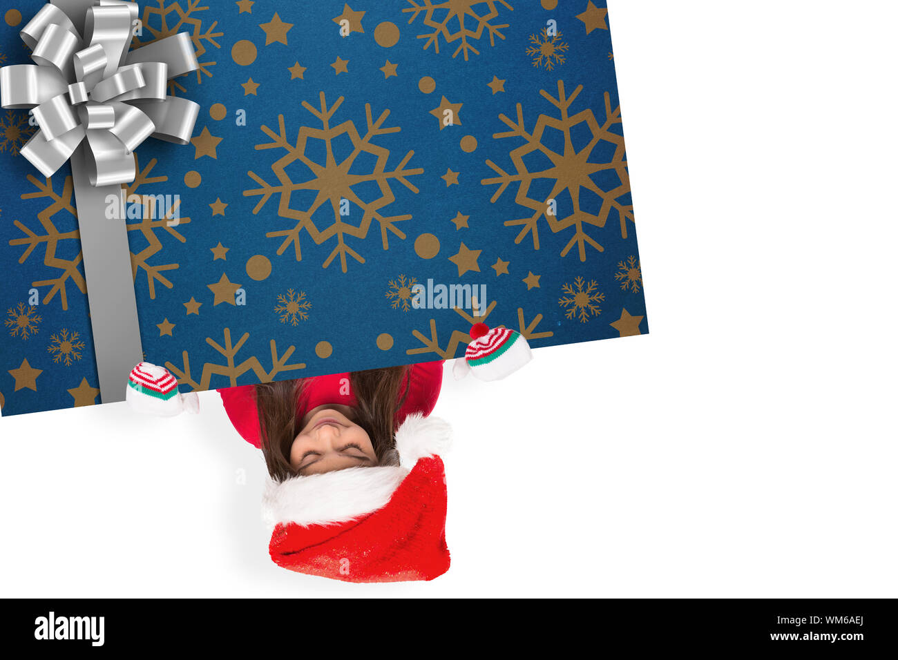 Festive little girl showing card against christmas wrapping paper with bow Stock Photo - Alamy