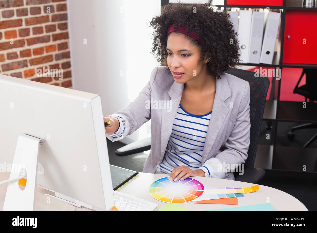 Casual female photo editor using computer in the office Stock Photo - Alamy